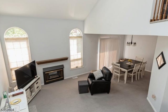 living room with light colored carpet and lofted ceiling