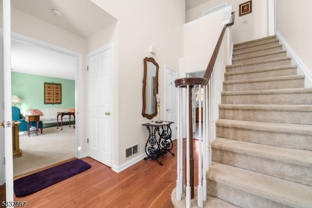 staircase with wood-type flooring