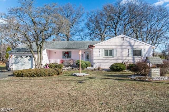 ranch-style home with a garage and a front lawn