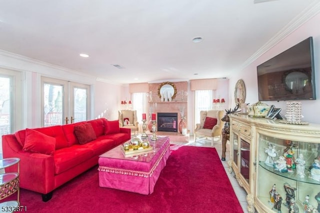 tiled living room featuring a premium fireplace, french doors, and crown molding