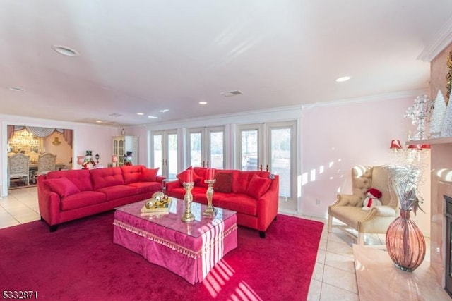 living room featuring a high end fireplace, french doors, light tile patterned flooring, and ornamental molding