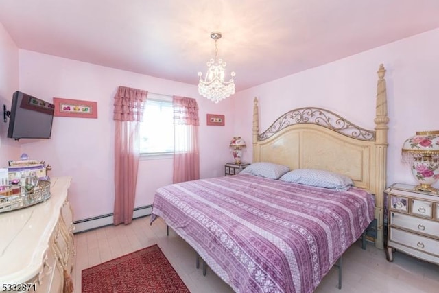 bedroom featuring a chandelier and baseboard heating