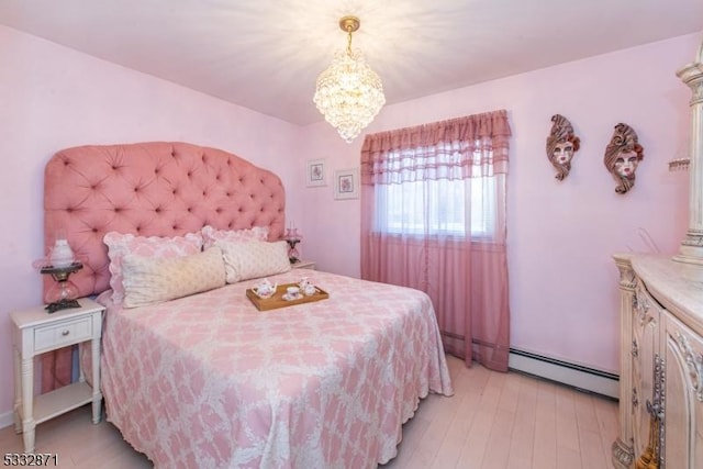 bedroom with a chandelier, a baseboard radiator, and light hardwood / wood-style floors