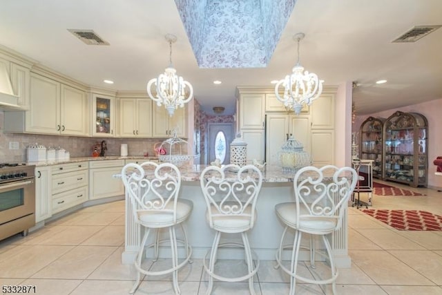 kitchen with hanging light fixtures and cream cabinets