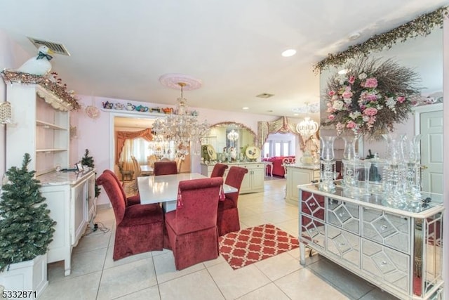 tiled dining space with a notable chandelier