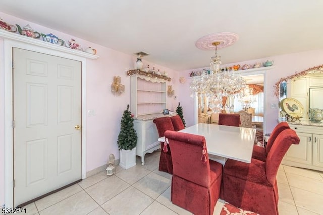 tiled dining area with a chandelier