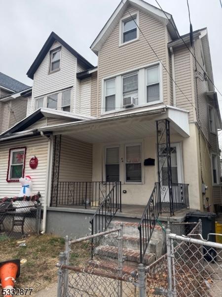 view of front of property featuring a porch and cooling unit