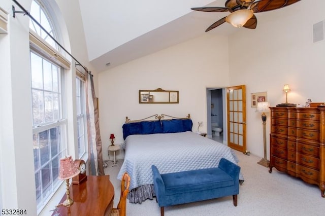 carpeted bedroom featuring ceiling fan and high vaulted ceiling