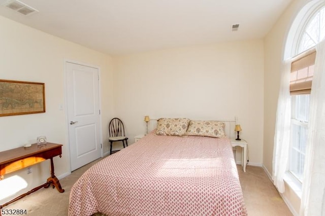 bedroom with light colored carpet