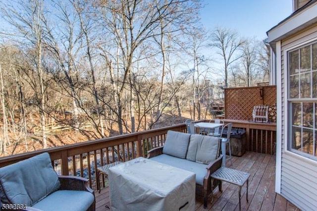 wooden terrace featuring an outdoor living space