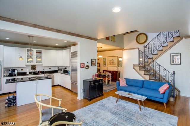 living room featuring a chandelier and light wood-type flooring