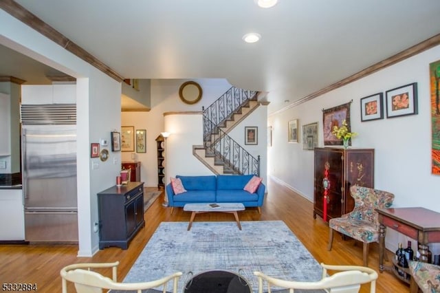 living room featuring crown molding and wood-type flooring