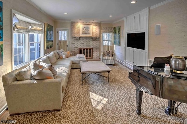 living room with a healthy amount of sunlight, a brick fireplace, and crown molding