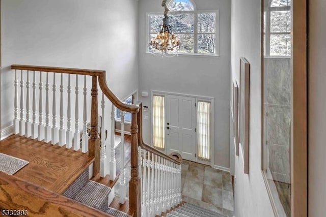 entryway featuring a notable chandelier and a high ceiling