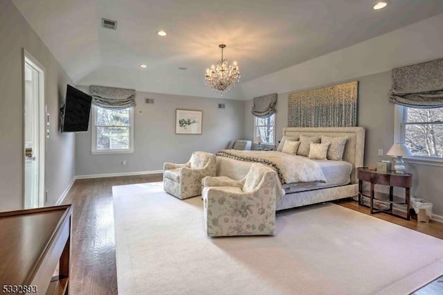 bedroom with vaulted ceiling, a chandelier, and hardwood / wood-style flooring