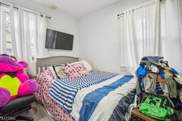 bedroom with hardwood / wood-style flooring