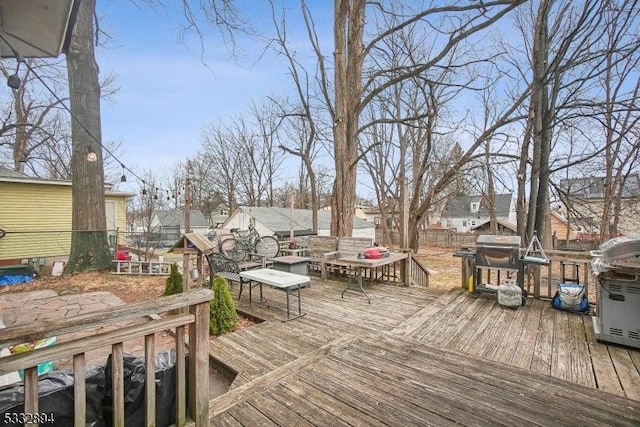 wooden deck featuring a grill