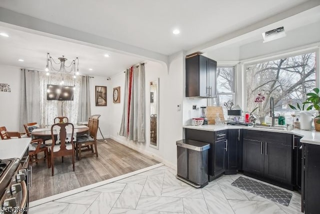 kitchen with gas stove and a chandelier