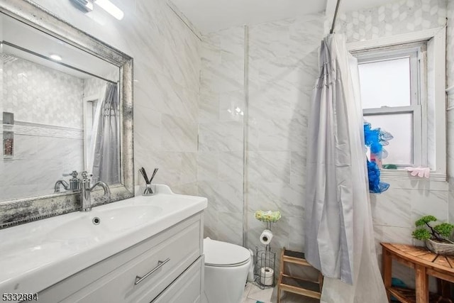 bathroom featuring toilet, vanity, tile walls, and curtained shower