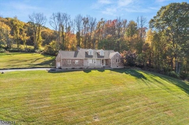 cape cod house with a front lawn