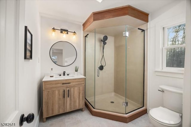 bathroom with vanity, toilet, tile patterned flooring, and an enclosed shower