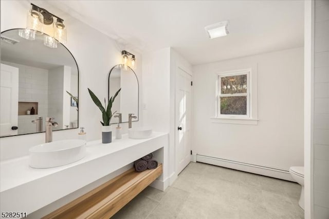 bathroom with baseboard heating, toilet, and vanity