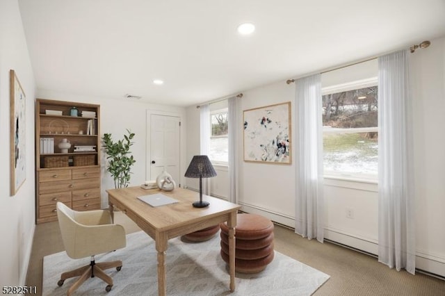 carpeted home office with a baseboard heating unit