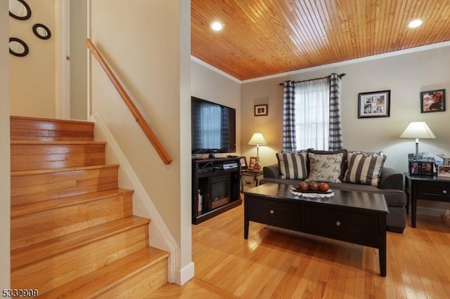 living room with crown molding, wooden ceiling, and light hardwood / wood-style floors