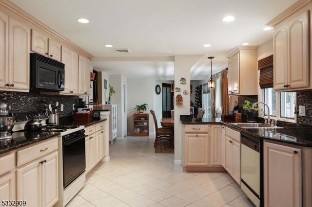 kitchen featuring pendant lighting, sink, gas stove, stainless steel dishwasher, and kitchen peninsula