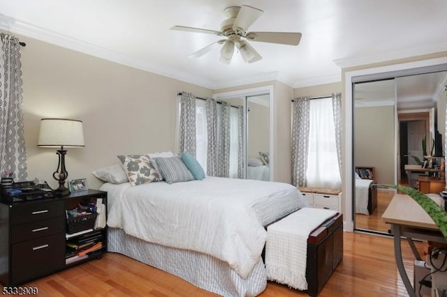 bedroom featuring crown molding, light hardwood / wood-style flooring, and ceiling fan