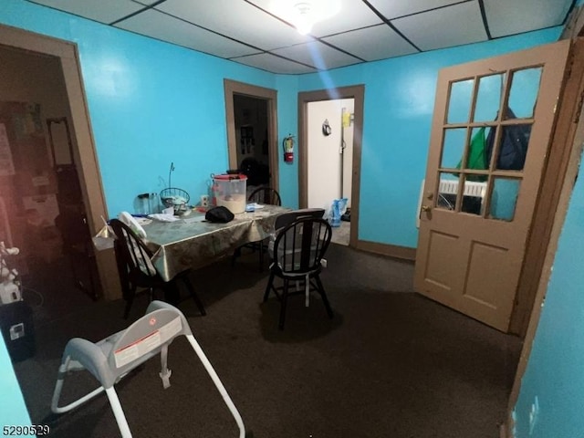 carpeted office featuring a paneled ceiling