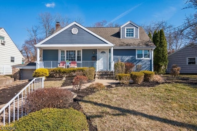 cape cod-style house featuring a garage, covered porch, and a shingled roof