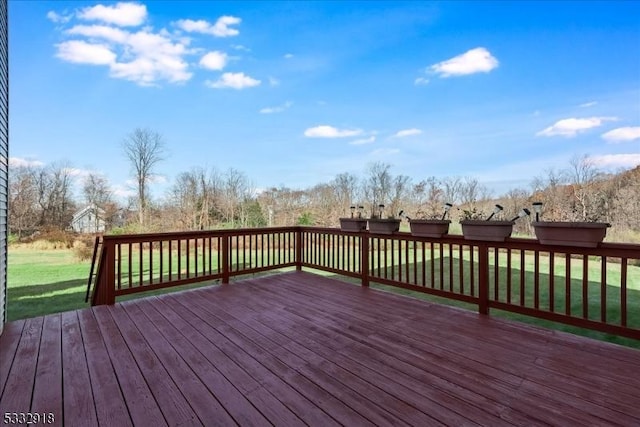 wooden deck featuring a yard