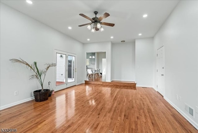 unfurnished living room featuring ceiling fan and wood-type flooring