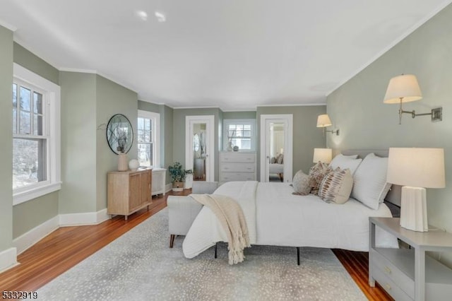 bedroom with wood-type flooring and ornamental molding