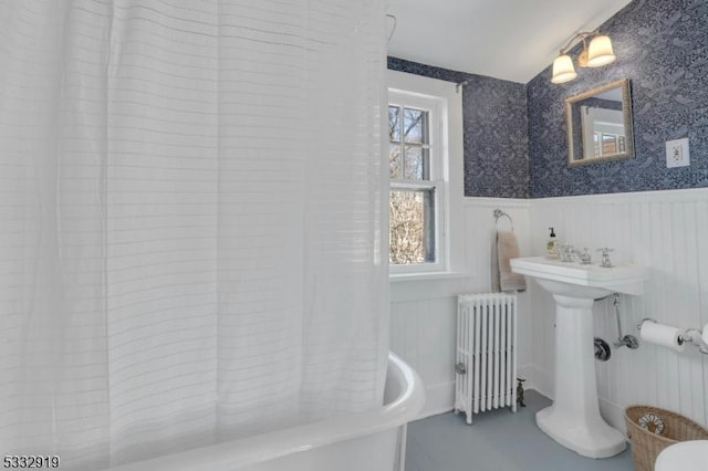 bathroom featuring shower / bath combination with curtain and radiator heating unit