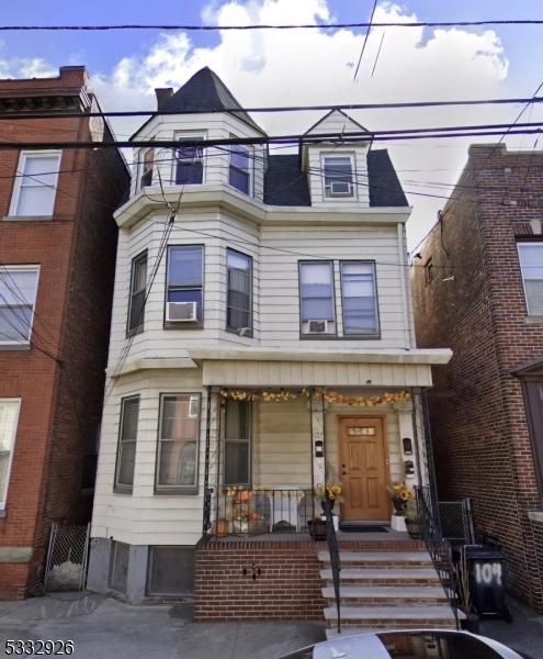 view of front of home featuring covered porch and cooling unit