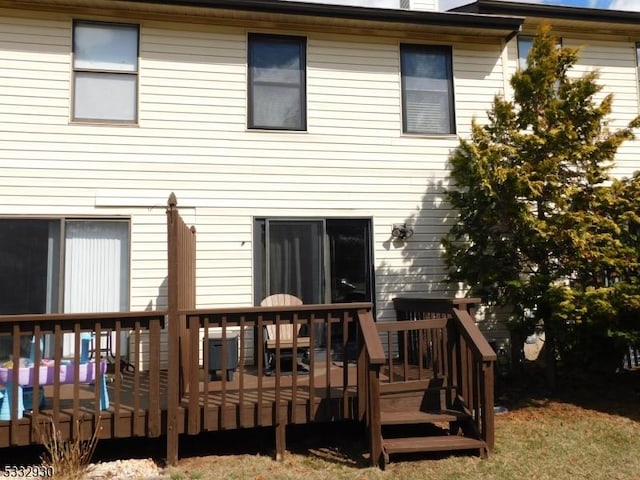 back of property featuring a deck