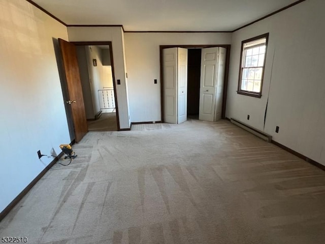 unfurnished bedroom featuring a baseboard heating unit, ornamental molding, and light carpet