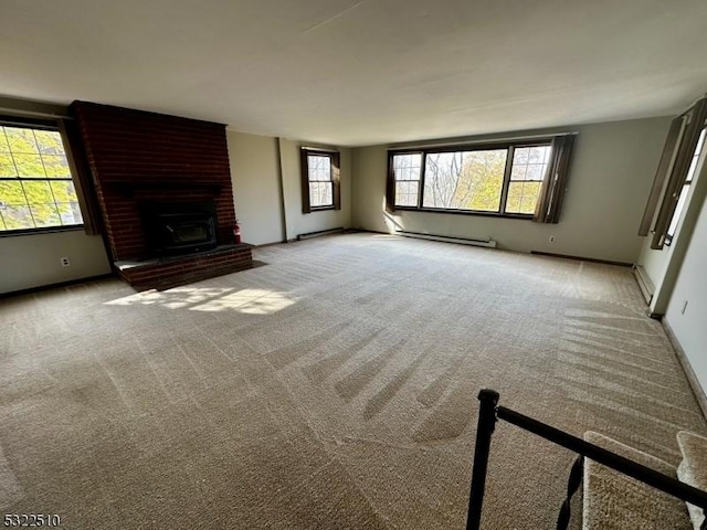 unfurnished living room with a brick fireplace, baseboard heating, and light colored carpet