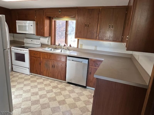 kitchen featuring sink and white appliances