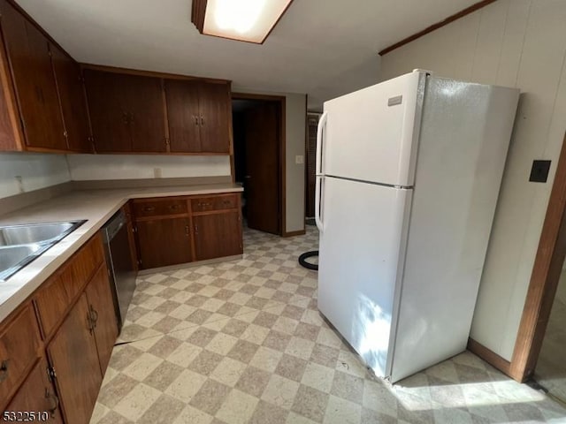 kitchen with sink, black dishwasher, and white fridge