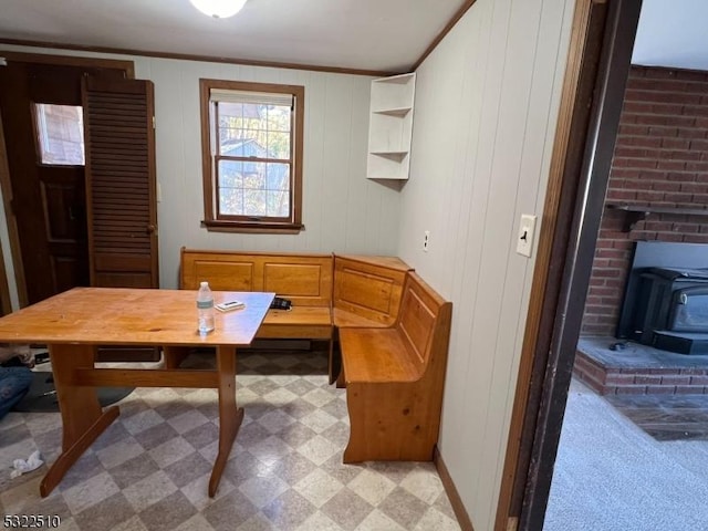 carpeted dining space featuring a wood stove