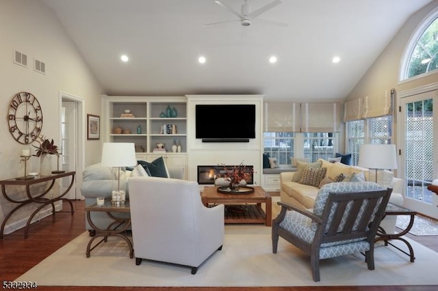 living room with ceiling fan, lofted ceiling, and light hardwood / wood-style flooring