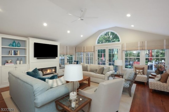 living room with ceiling fan, french doors, dark hardwood / wood-style floors, and lofted ceiling