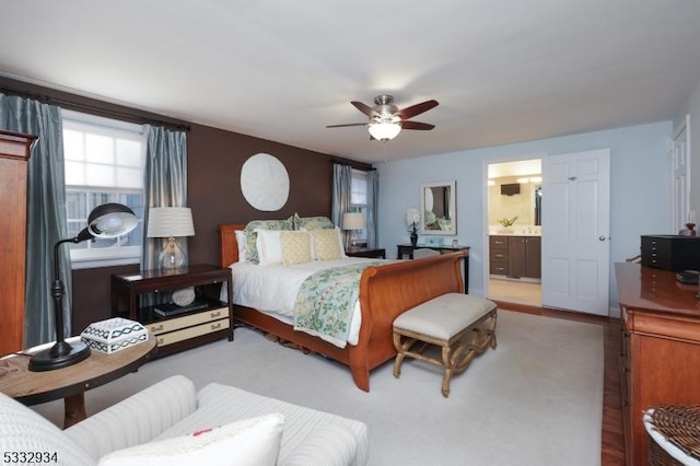 bedroom featuring ceiling fan, carpet, and connected bathroom