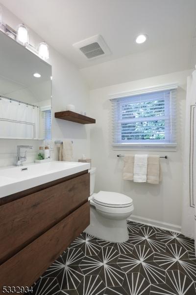 bathroom featuring toilet and vanity