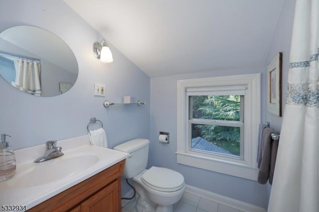 bathroom with vaulted ceiling, toilet, tile patterned floors, and vanity