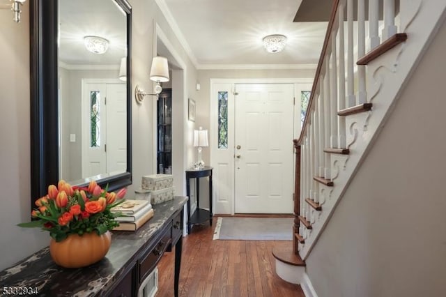 entryway featuring dark hardwood / wood-style flooring and ornamental molding