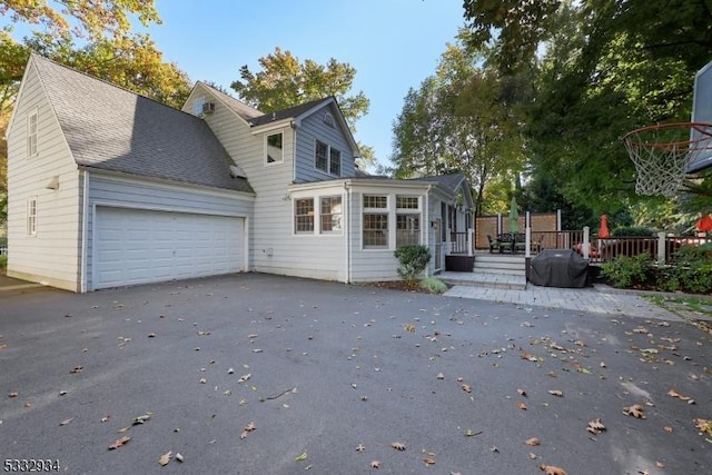 rear view of property featuring a garage